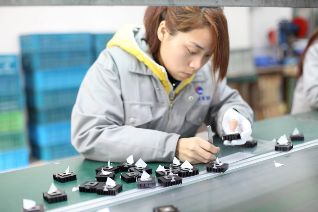 Workers at stations on an assembly line