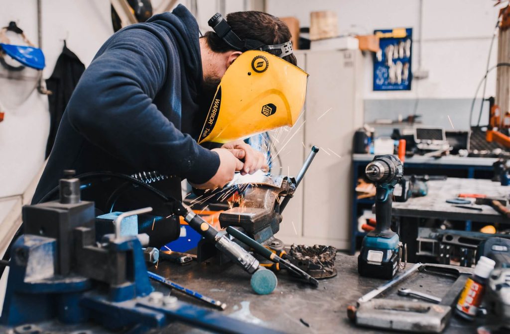 Man welding at a workstation