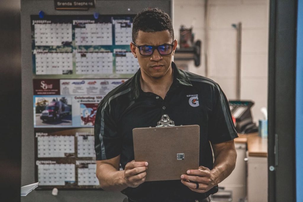 A man holding a clipboard, ready for a Gemba walk