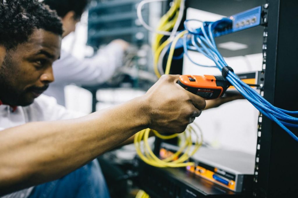 A technician carrying out maintenance on factory equipment