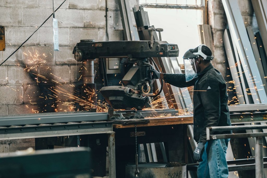 manufacturing worker who needs re-skilling behind a cutting machine