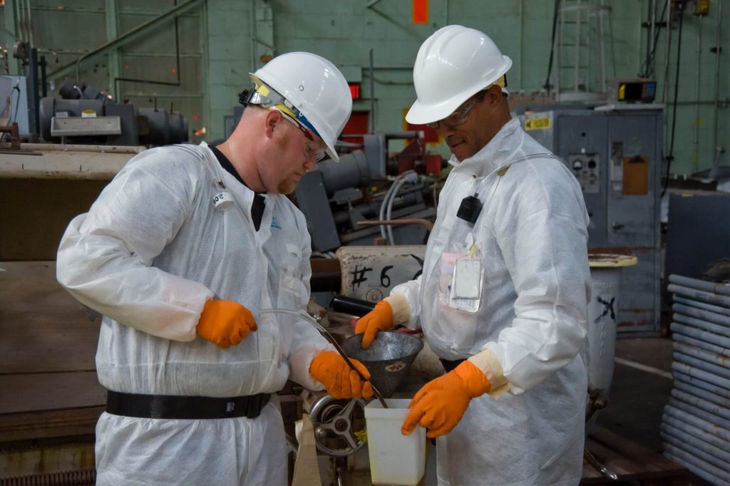 Two workers in a factory working together