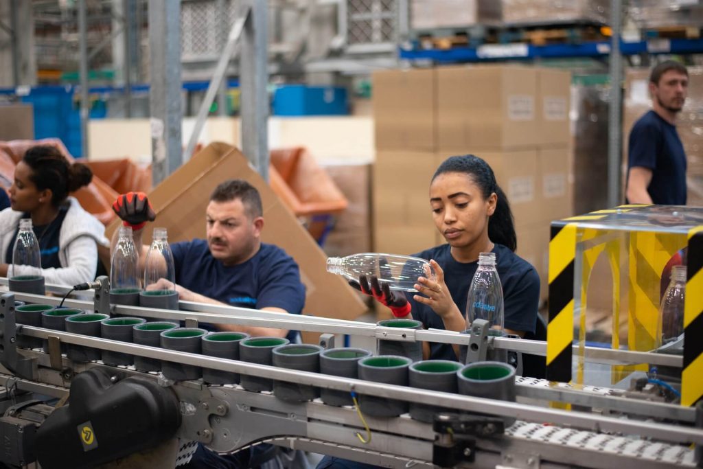 woman behind an assembly line