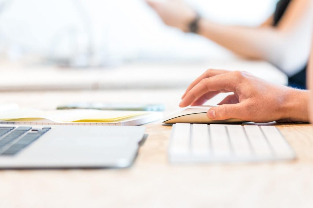 A person who is writing work instructions on their computer