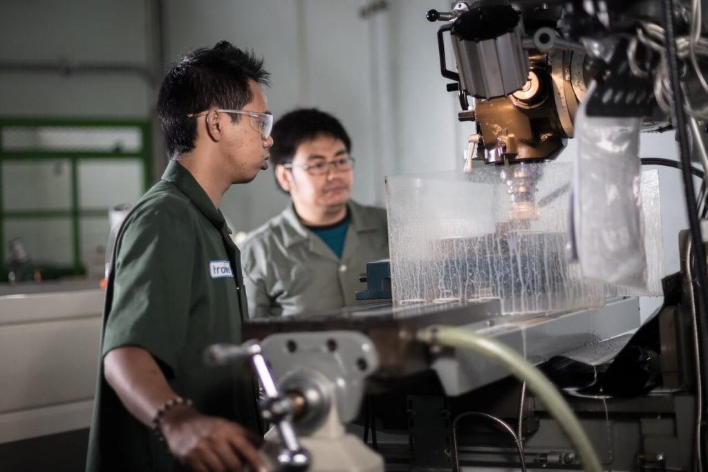 Two people working in a machine shop